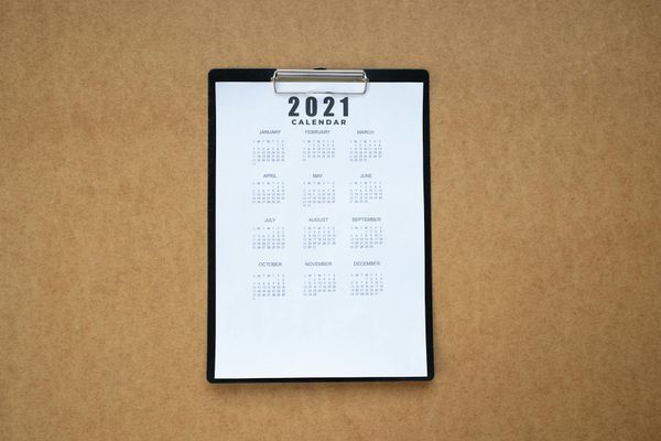 A calendar or planner with gym and yoga icons marked on different days.