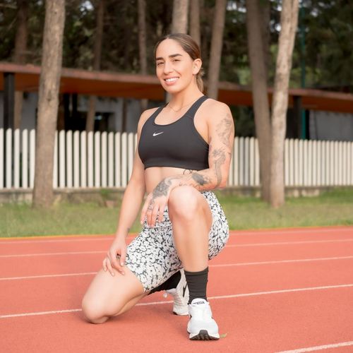 Portrait of a smiling female runner in sportswear.